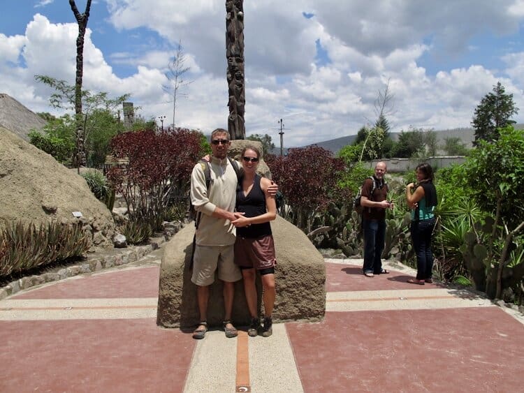 A couple posing for photo on equatorial line in Ecuador