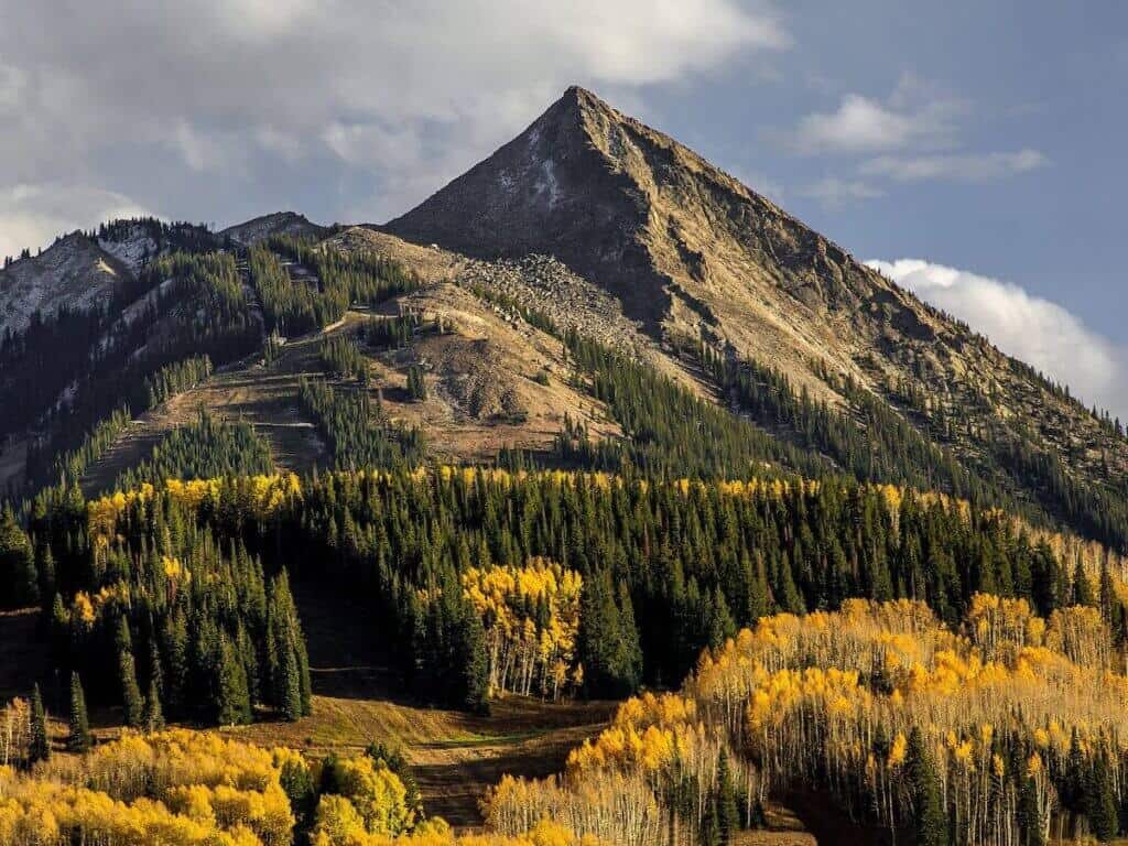 Landscape photo of mountain peak in Crested Butte Colorado in fall with golden aspen leaves