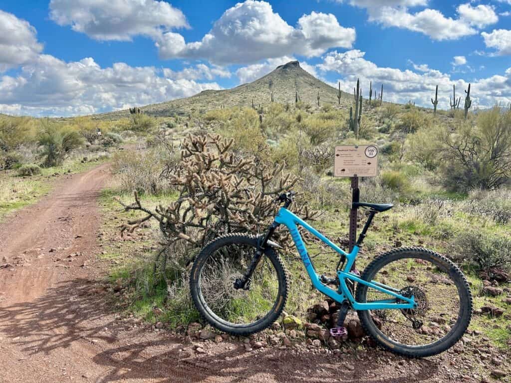 Mountain bike leaning against trail sign on desert trail at Brown's Ranch in Phoenix, Arizona
