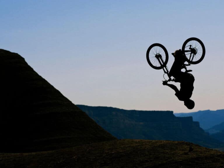 Silhouette of mountain biker doing backflip
