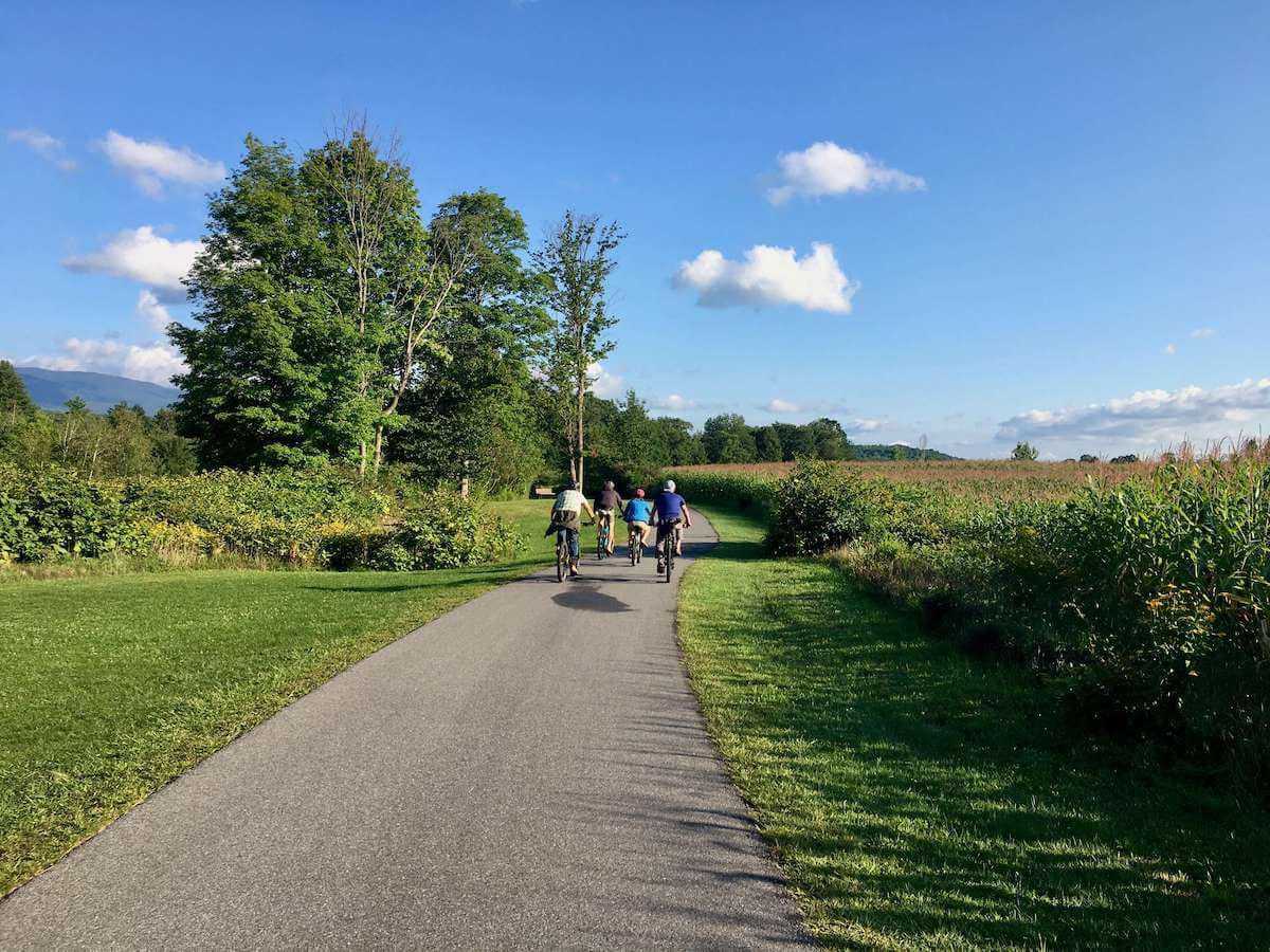 Cyclists pedaling along Stowe Recreation path in Vermont