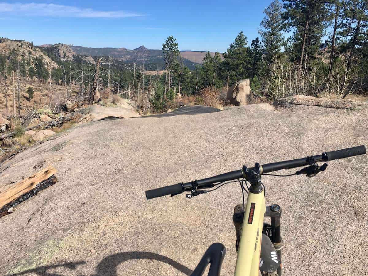 Photo out over front of mountain bike on rock slab trail in Buffalo Creek, Colorado