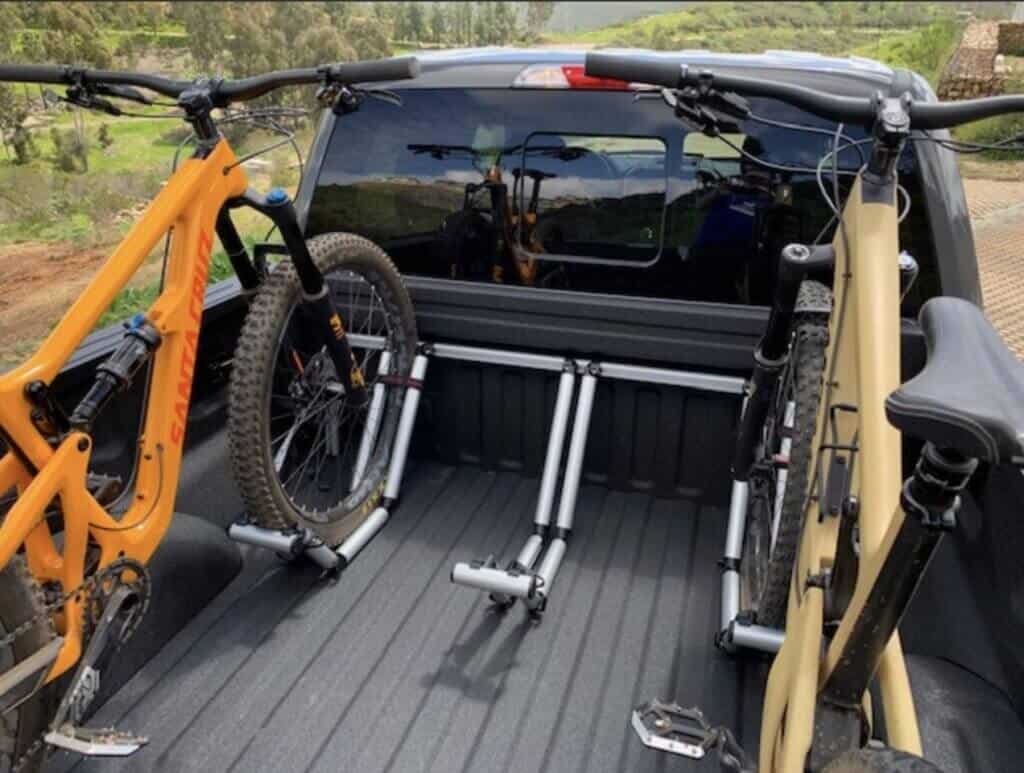 Two mountain bikes in back of truck bed secured by Pipeline bike rack