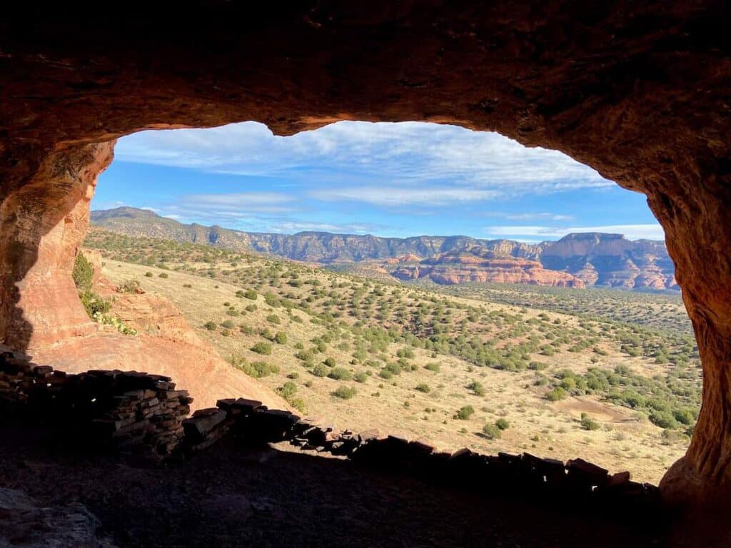 Photo from inside Robbers Roost cave looking out over red rock landscape around Sedona, Arizona