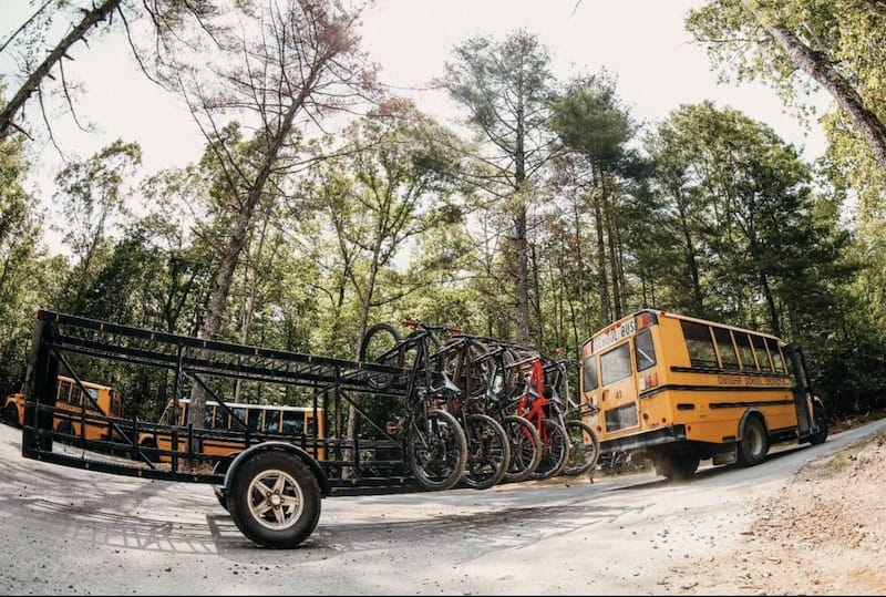 Bus pulling bike rack trailer at Ride Rock Creek Bike Park in North Carolina