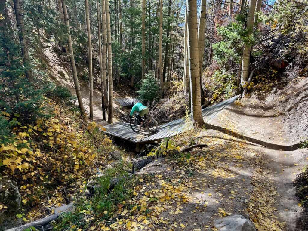 Mountain biker on bridge on flow trail at bike park