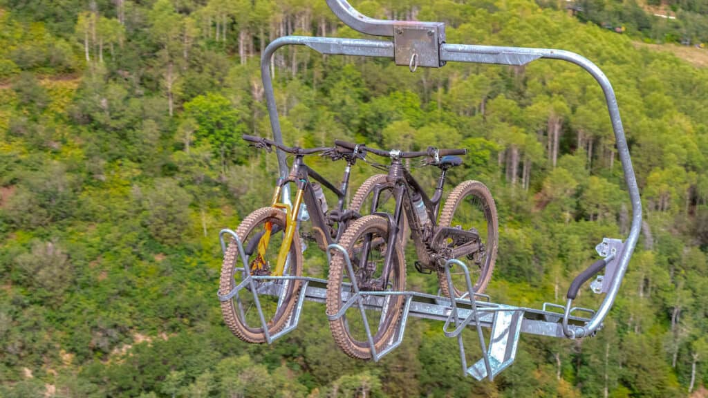 Two bikes on bucket rack bike park chairlift