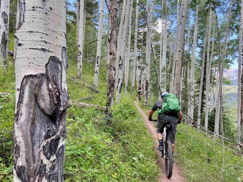 Mountain biker wearing Osprey Manta 34 backpack on bikepacking trip through Colorado