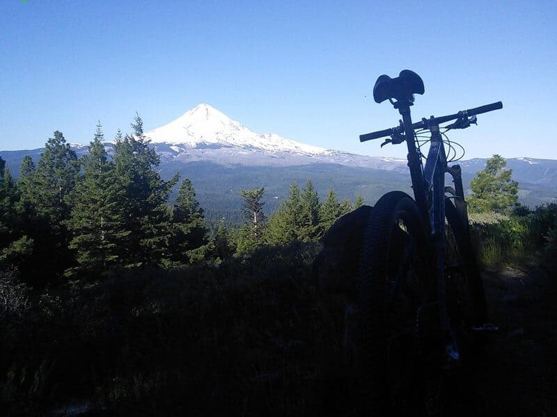 Mountain bike silhouetted against snow-capped Mt. Hood in Oregon