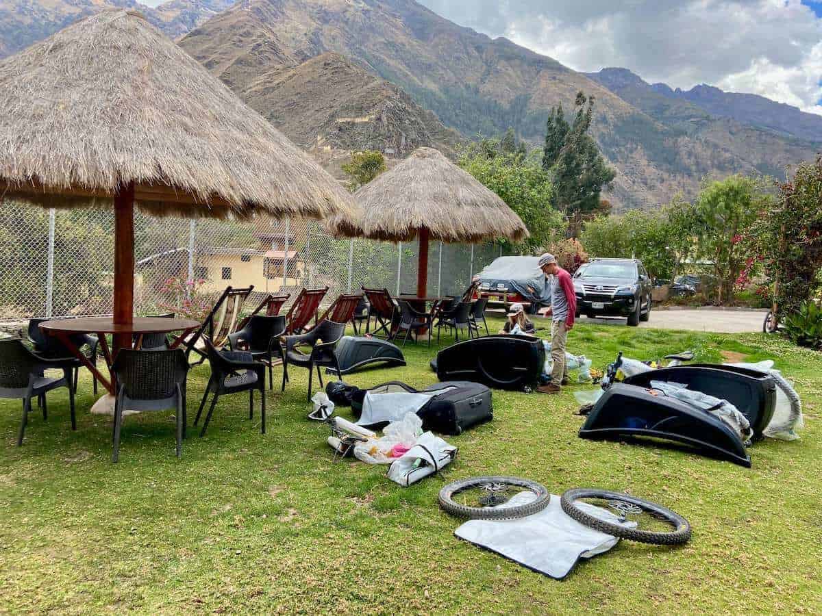 Mountain bikers putting together mountain bikes on lawn of hotel on mountain bike trip in Peru
