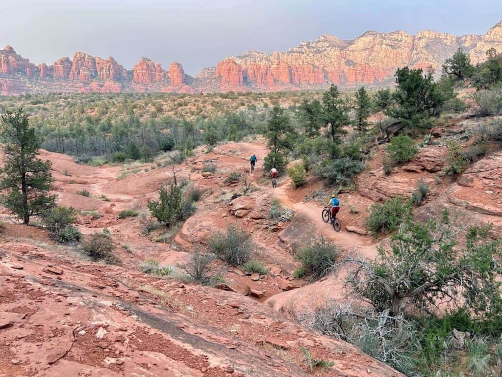 Beautiful red rock landscape photo in Sedona with mountain bikers on trail