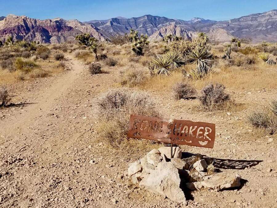 Metal trail sign that says Boneshaker on mountain bike trail outside Las Veags