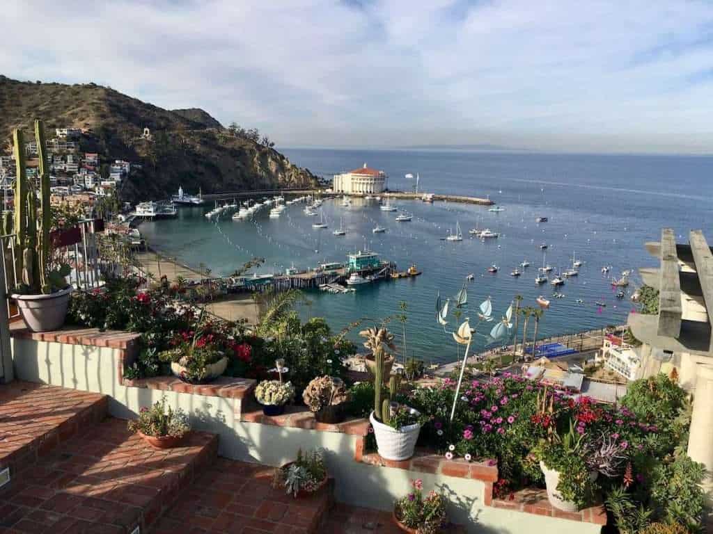 View of Catalina Island Harbor with round opera house on the far side and sail boats moored in the bay. 