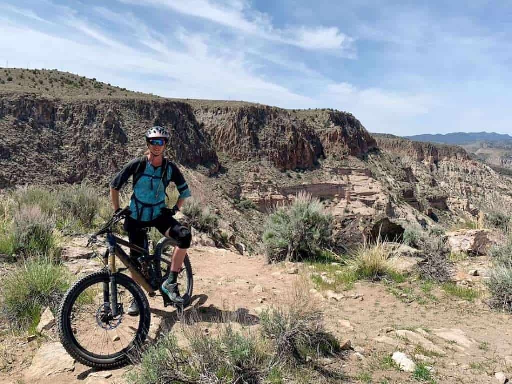 Becky posing for photo on mountain bike while riding singletrack trail in Caliente, Nevada