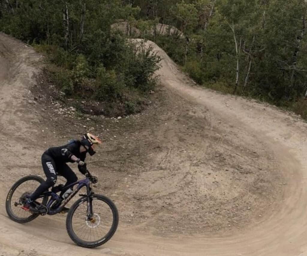 Mountain biker on machine-built flow trail at WinSport Bike Park in Alberta, Canada