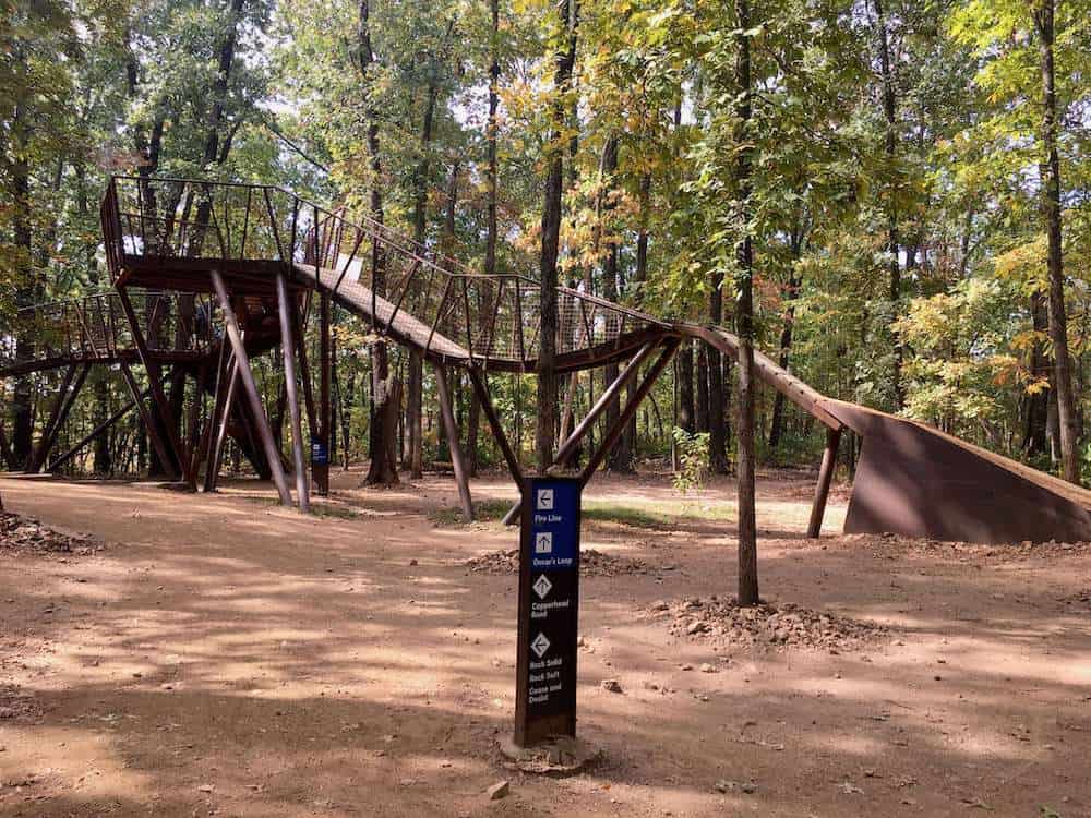 A wooden 'hub' for mountain bikers at Coler Preserve in Bentonville with ramps leading down into different trails
