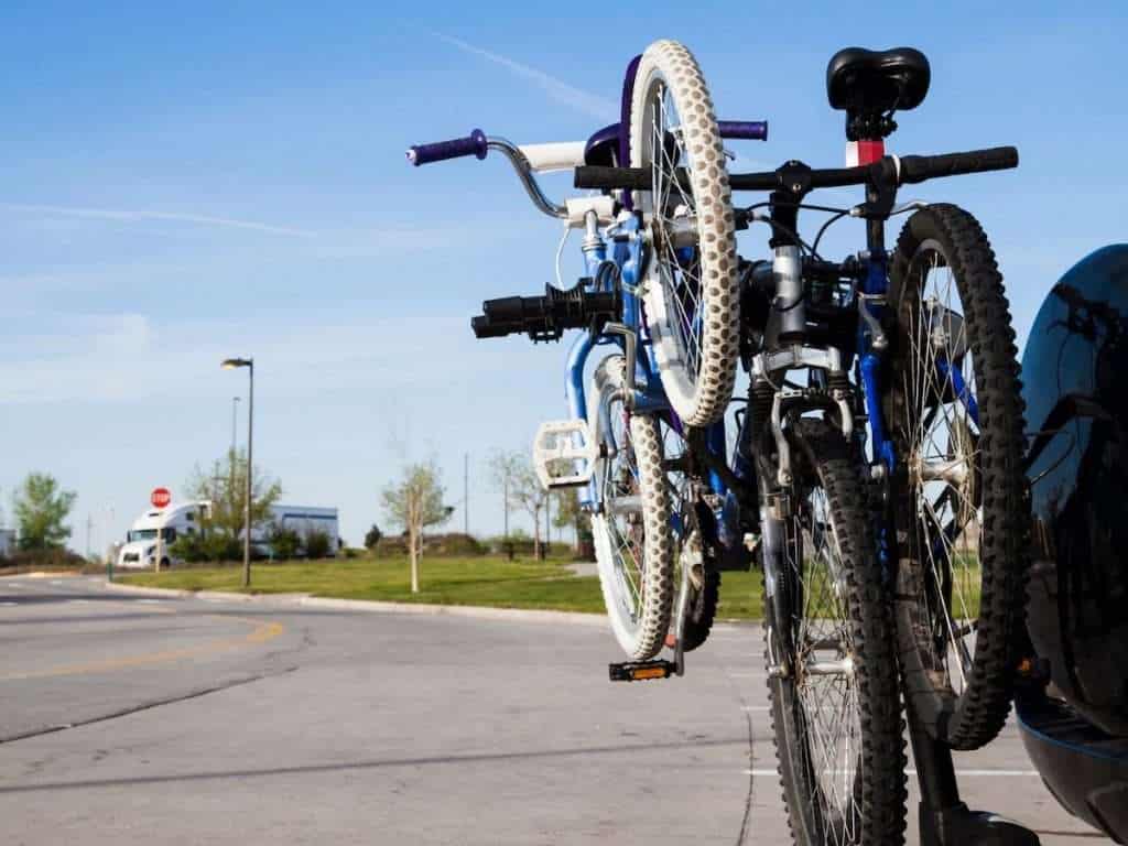 Three bikes on bike rack on rear of vehicle