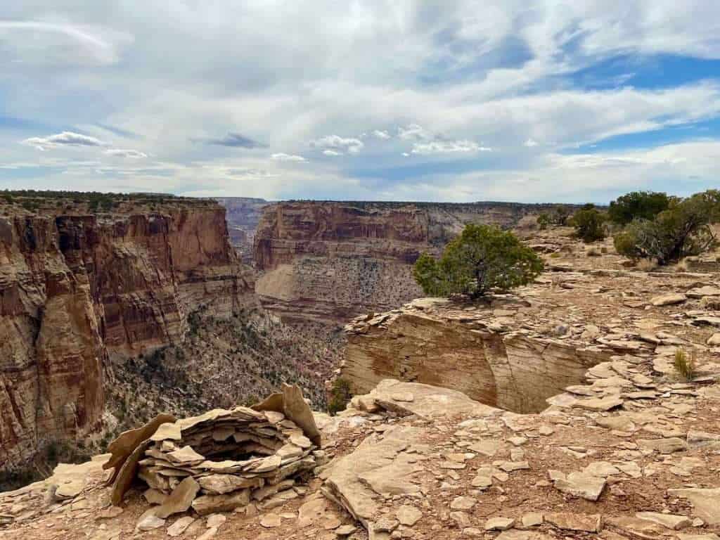 Rock fire pit at edge of canyon rim in Utah with expansive views 
