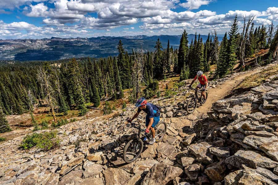 Two mountain bikers riding on rocky section of trail at Brundage Bike Park in Idaho