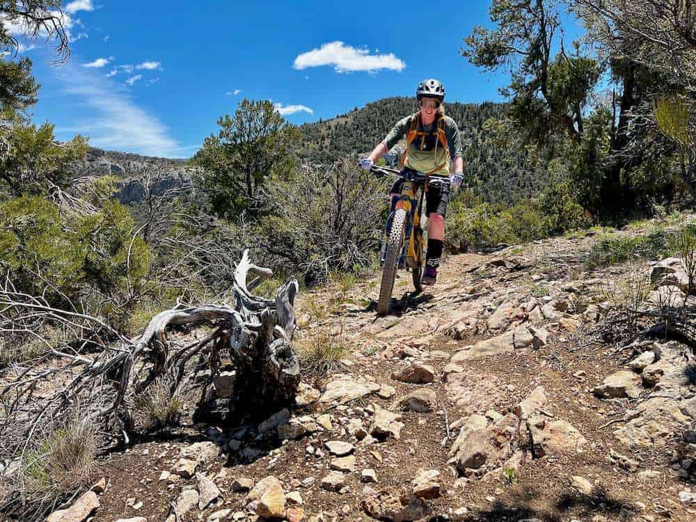 Becky riding mountain bike on rocky trail in Ely, Nevada