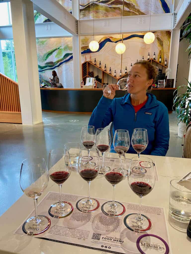 Michelle tasting a glass of red wine at a tasting room in Woodinville, Washington