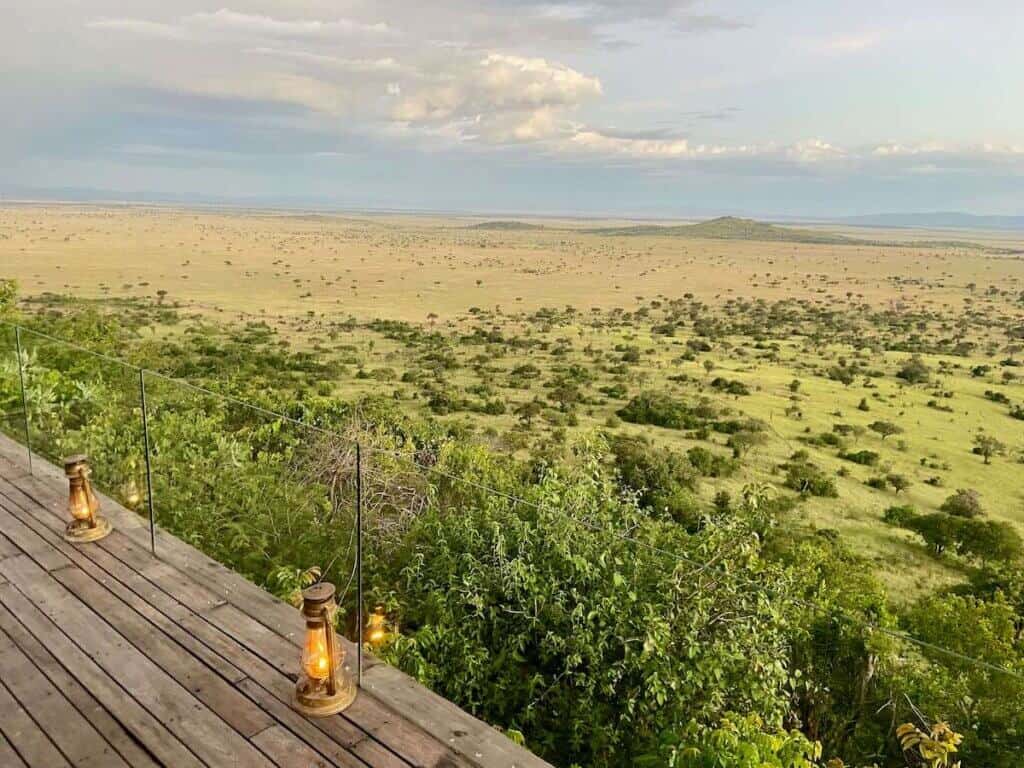 View out over lush green Grumeti Game Reserve from deck of Sasakwa Lodge in Tanzania
