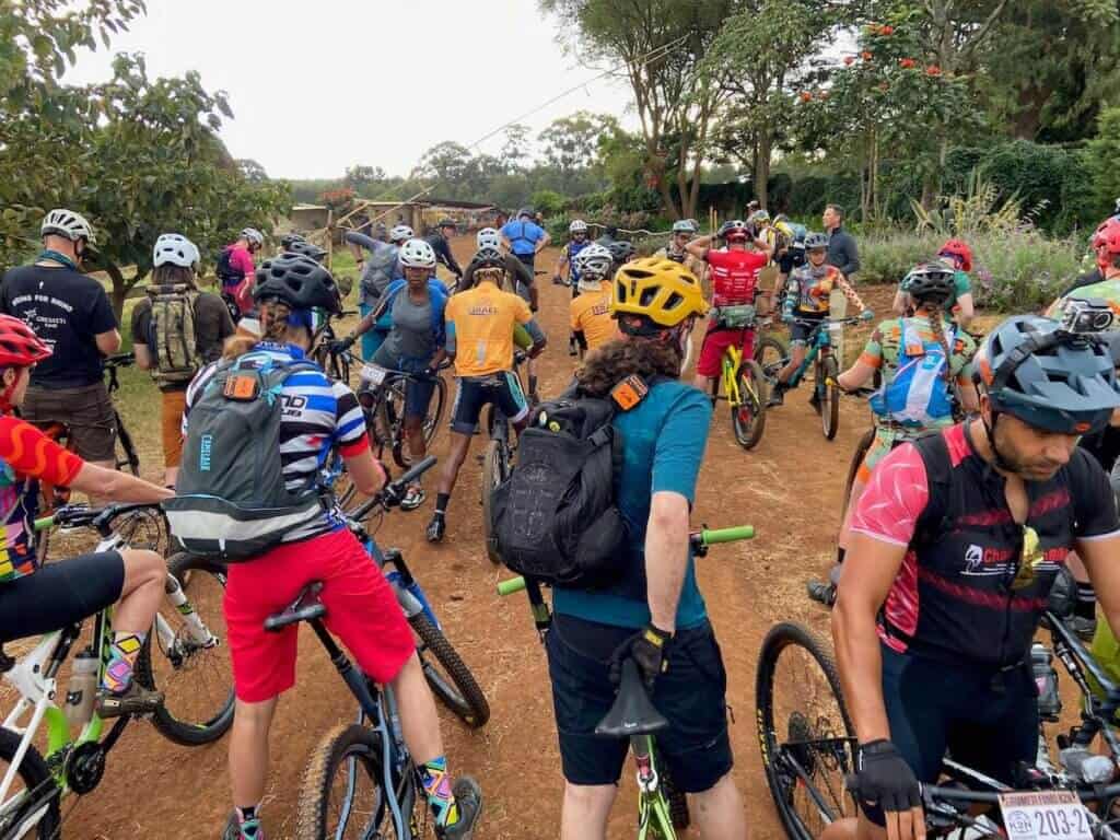 Group of mountain bikers gathering at gate to start K2N mountain bike race in Tanzania