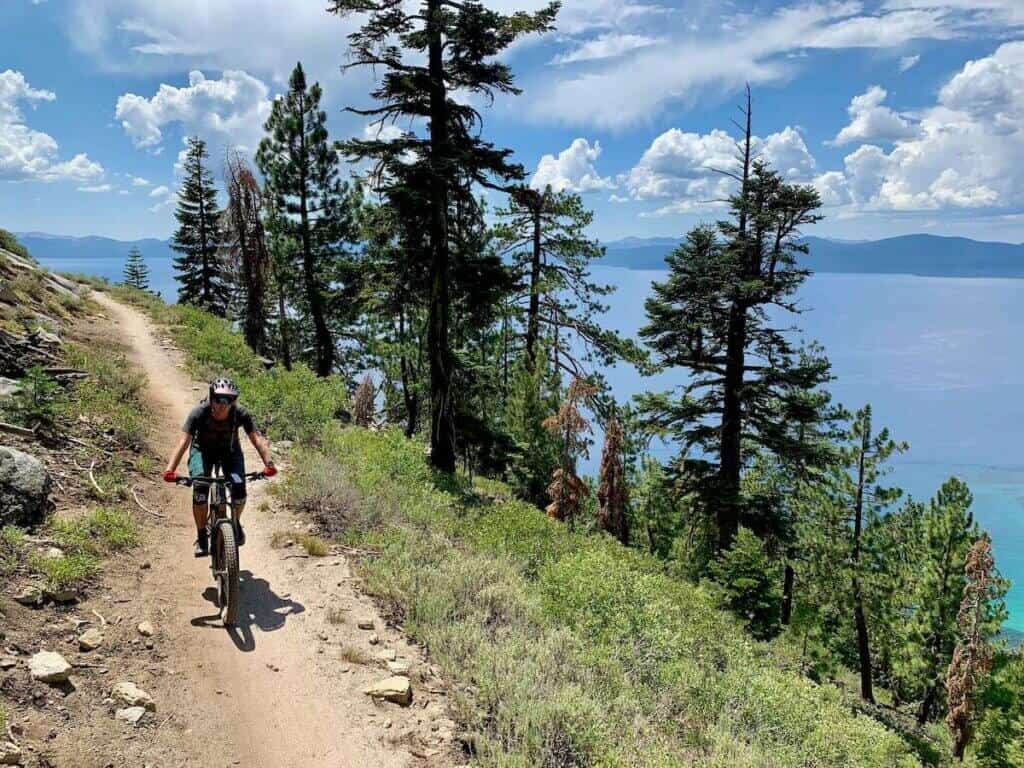 Mountain biker on singletrack trail high above Lake Tahoe in Nevada