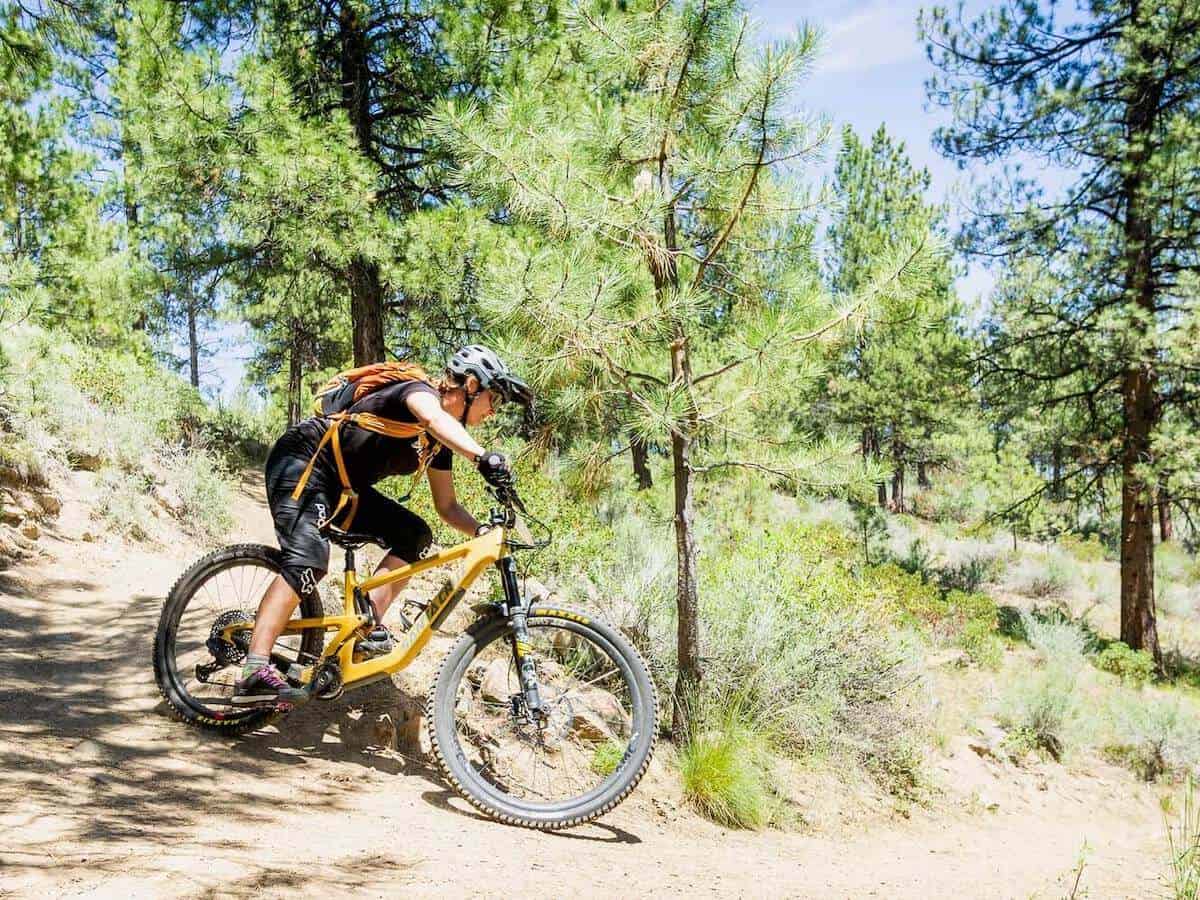 Becky riding mountain bike around tight switchback corner