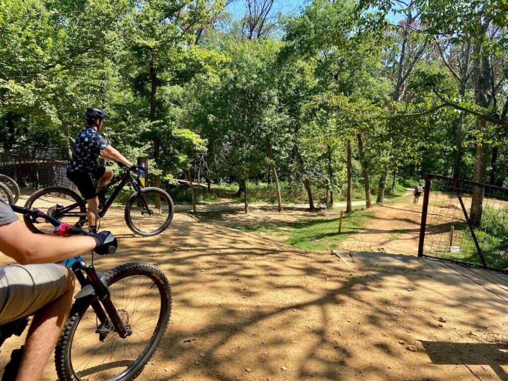 Mountain bikers that the top of a dual slalom track at Coler Preserve in Bentonville, Arkansas