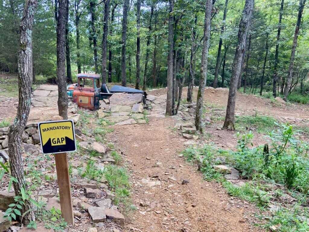 Mountain bike trail in Arkansas with old car as a trail feature