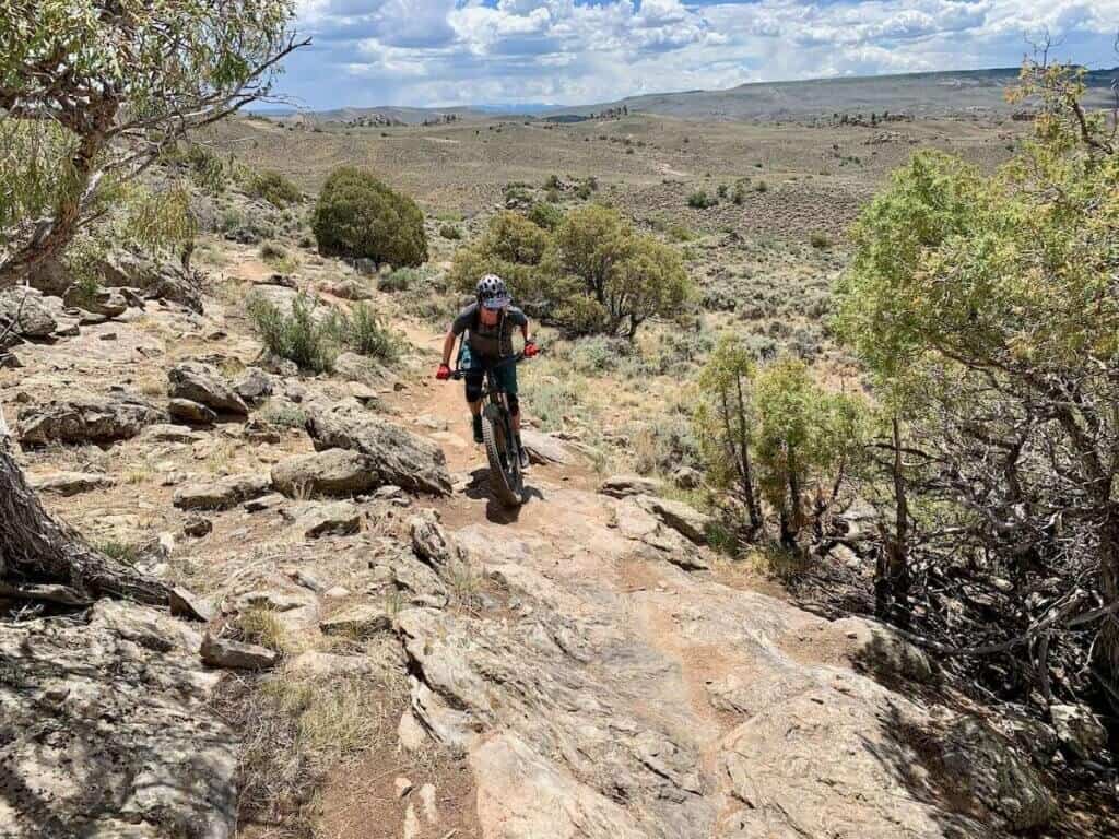 Becky climbing technical section of mountain bike trail at Hartman Rocks area in Coloraod