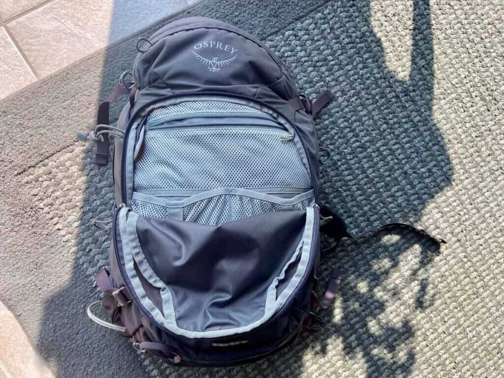 Showing organizational pockets on the Osprey Mira backpack