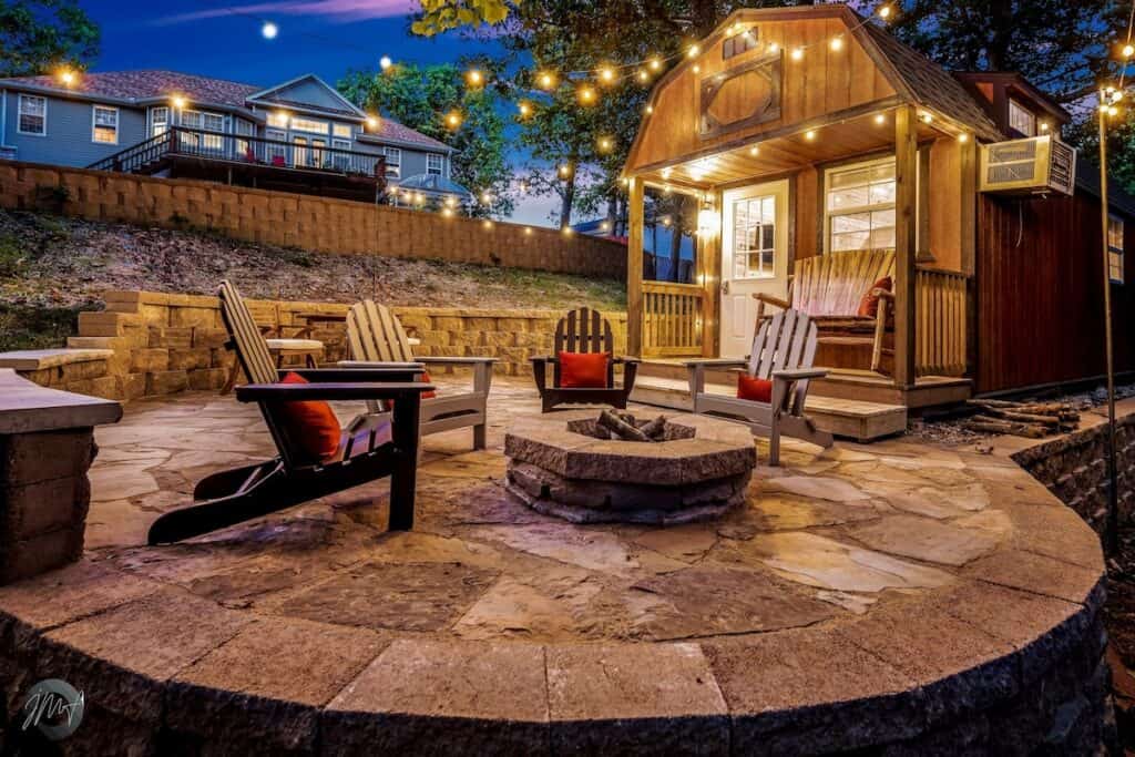 Stone fire pit patio lit up by lighgts
