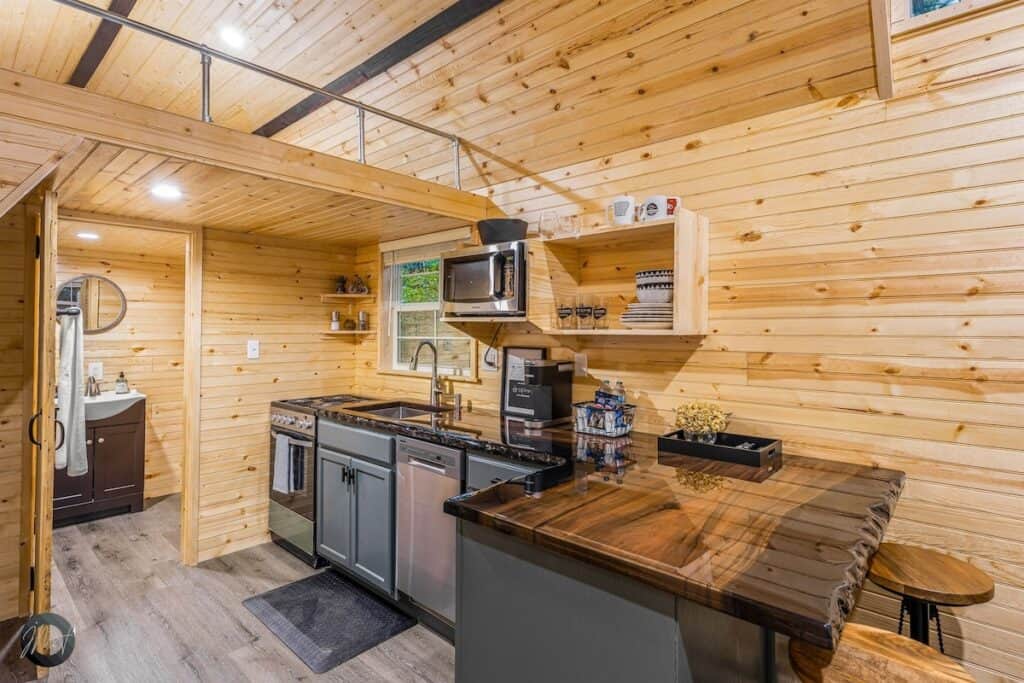 a kitchen with a wood wall and a wood floor