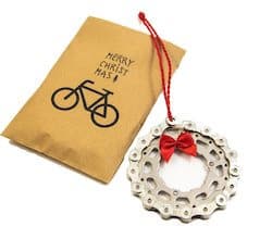 Christmas ornament of a wreath made out of a recycled bike chain with a bow at the top
