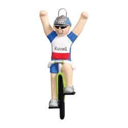 Christmas ornament of male cyclist on bike with arms in the air