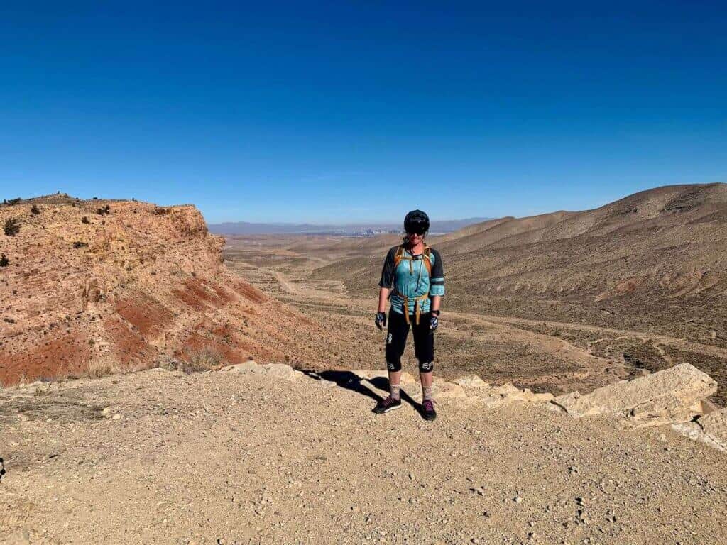Female mountain biker standing at desert overlook near Las Vegas