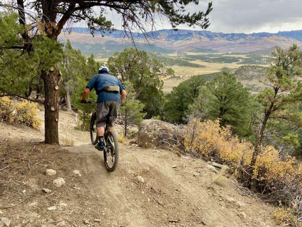 Mountain biker riding down singletrack trail near Ridway Coloraod