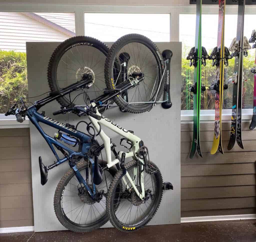 Two bikes hanging at a diagonal on Steadyrack bike rack in garage 