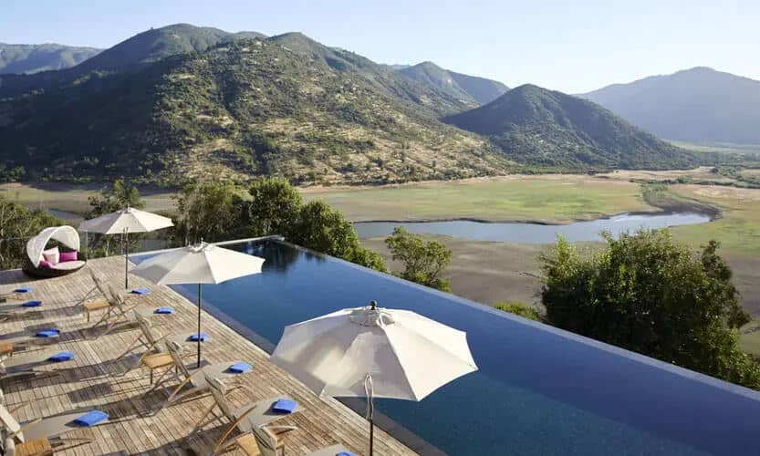 View of Chilean wine country landscape out over pool at luxury hotel