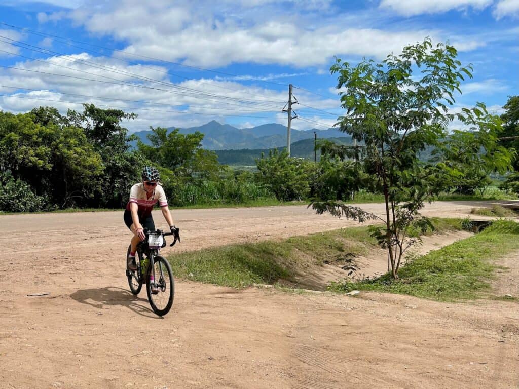 Woman riding gravel bike on dirt road