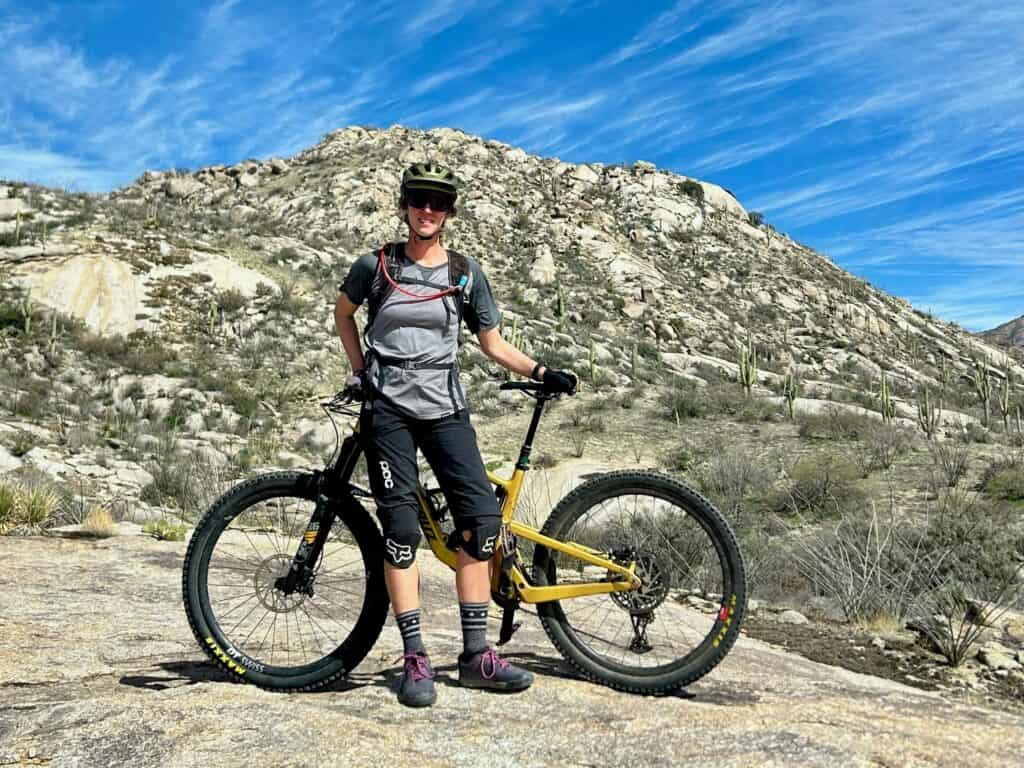 Woman standing in front of mountain bike