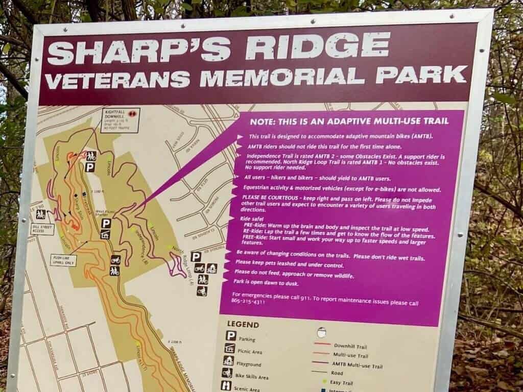 Trail sign at Sharp's Ridge Veterans Memorial Park in Knoxville saying that this mountain bike trail is an adaptive mountain bike trail