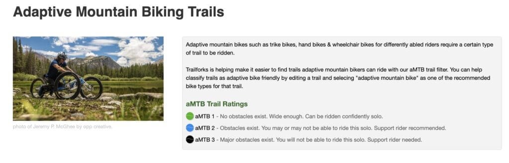 Screenshot of Adaptive Mountain Bike Trail Ratings from TrailForks website with photo of adaptive mountain biker riding three-wheeled bike