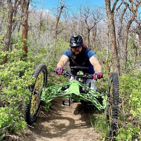 Matthew Tilford riding trail on adaptive mountain bike