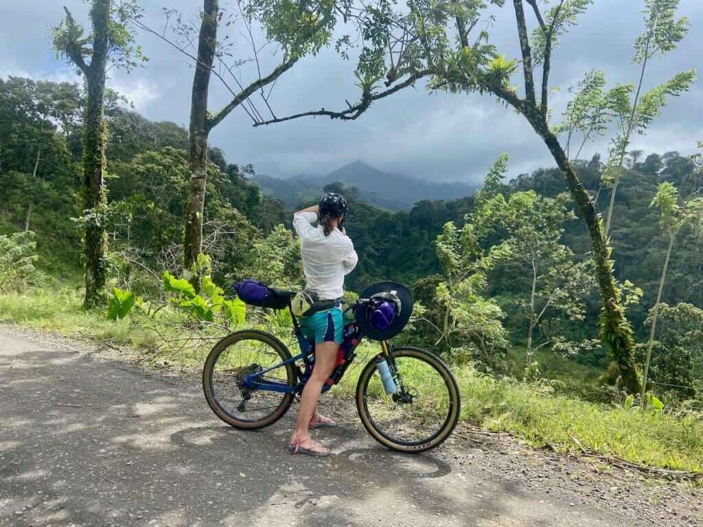 Bikepacking taking photo of scenic mountain view on bikepacking trip in Costa Rica