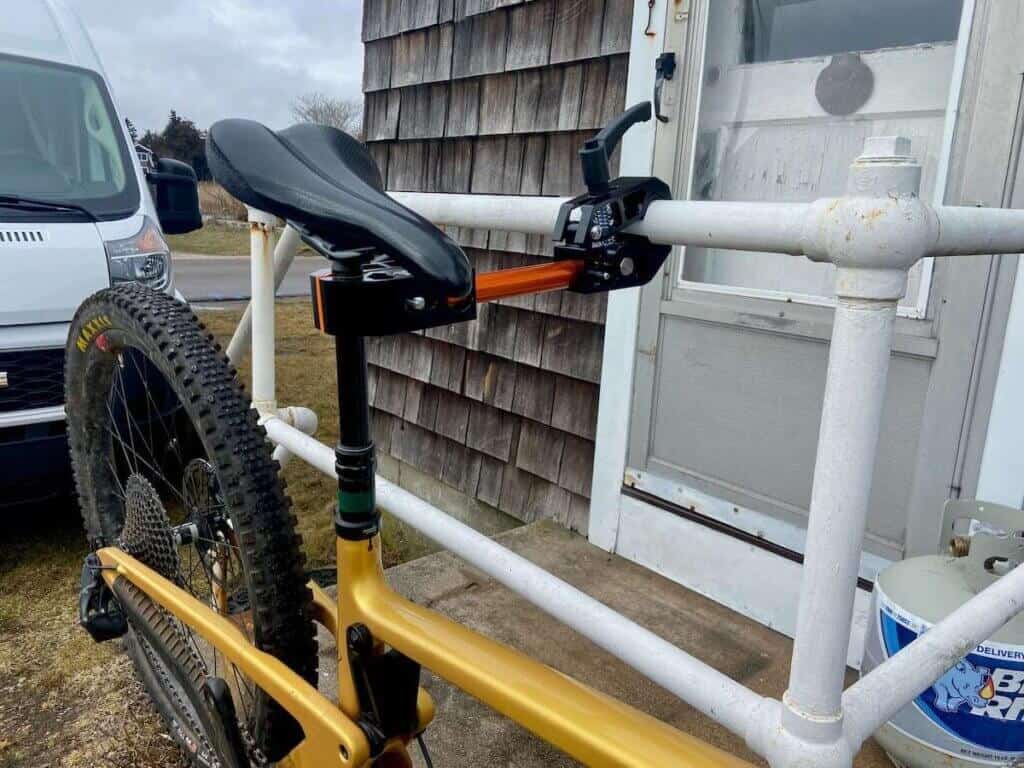 Altangle Portable Bike Stand holding mountain bike and attached to metal railing