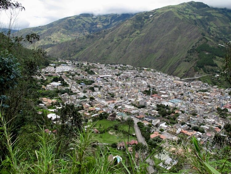 Views out over town of Baños Ecuador from above with steep Andes mountains on both sides