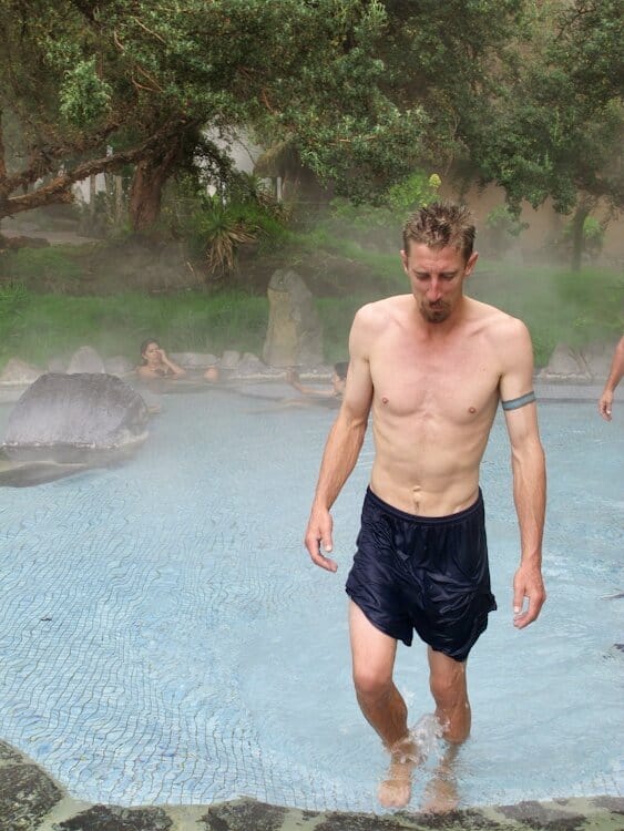 Man emerging from thermal pool at hot springs resort in Ecuador